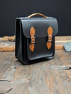 Small Portrait Backpack with a 25mm Volume Boost, Full Inner Slip Pocket, Outer Slip Pocket and Key Loop made from Charcoal Black and London Tan Leathers (MMRP USD$390)